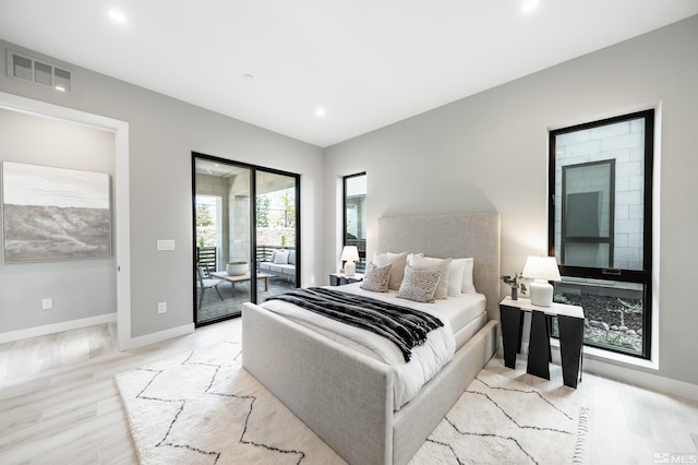 bedroom with light hardwood / wood-style floors and access to exterior