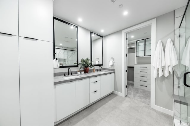 bathroom featuring tile patterned flooring, double sink vanity, and a shower with shower door