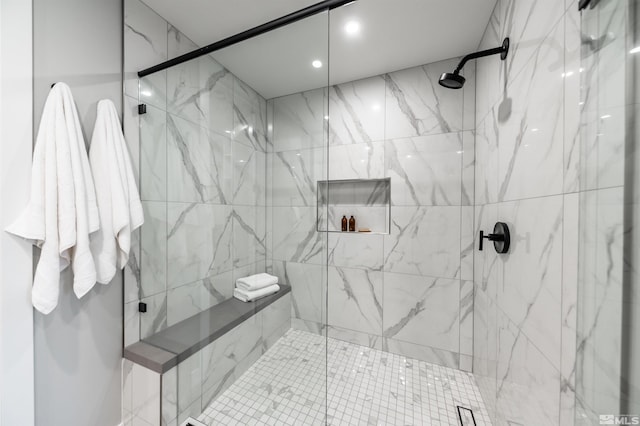 bathroom with a shower with door