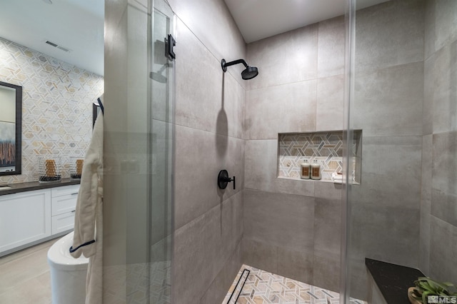 full bath featuring a stall shower, visible vents, and vanity