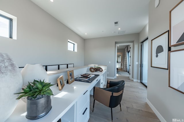 kitchen featuring baseboards, white cabinets, light wood-style flooring, light countertops, and recessed lighting