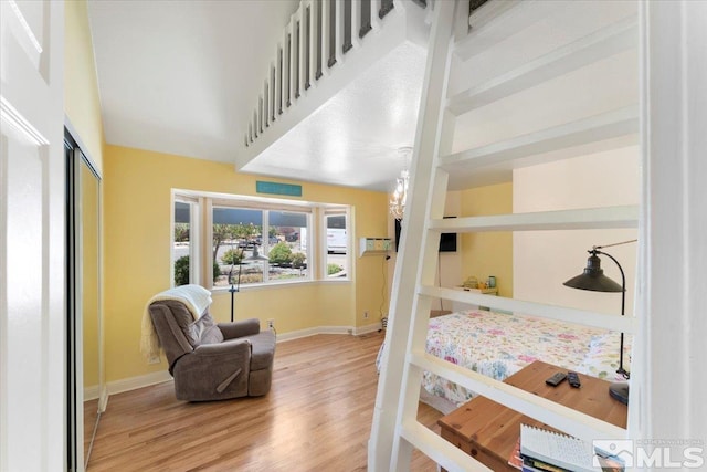 bedroom with a closet, baseboards, and wood finished floors