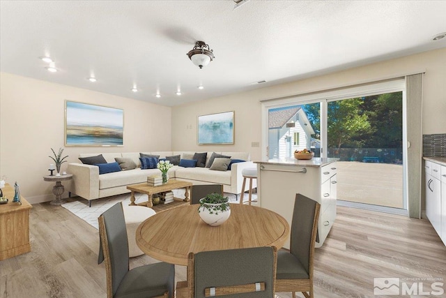 dining area featuring light wood-type flooring, visible vents, baseboards, and recessed lighting