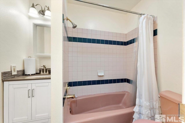 full bathroom with vanity, shower / bath combo with shower curtain, and toilet