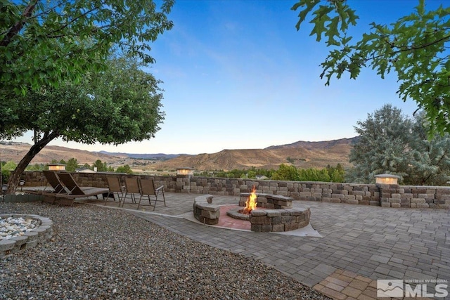 view of yard with an outdoor fire pit, a patio, and a mountain view