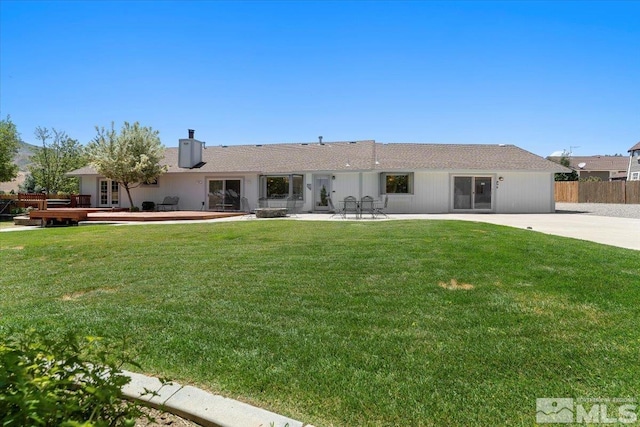 back of house with a yard, a patio, a wooden deck, and fence