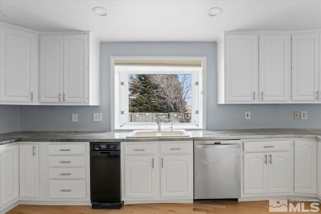 kitchen featuring dishwasher, light wood-type flooring, a sink, and white cabinetry