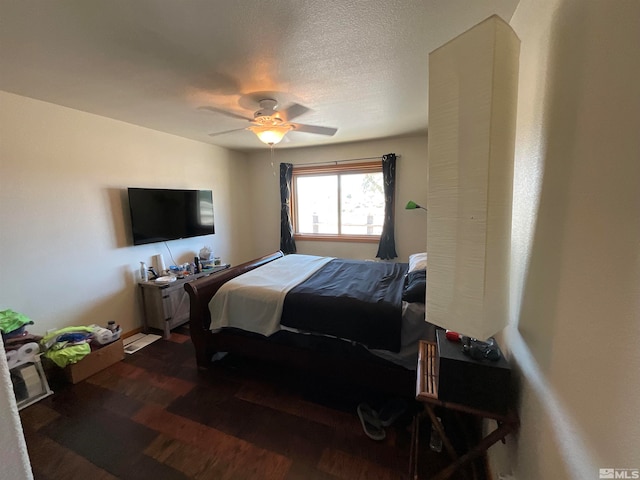 bedroom with a textured ceiling, ceiling fan, and hardwood / wood-style floors