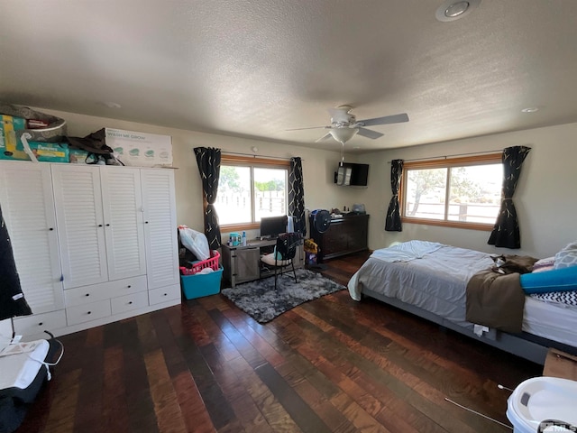 bedroom featuring a textured ceiling, ceiling fan, and hardwood / wood-style floors