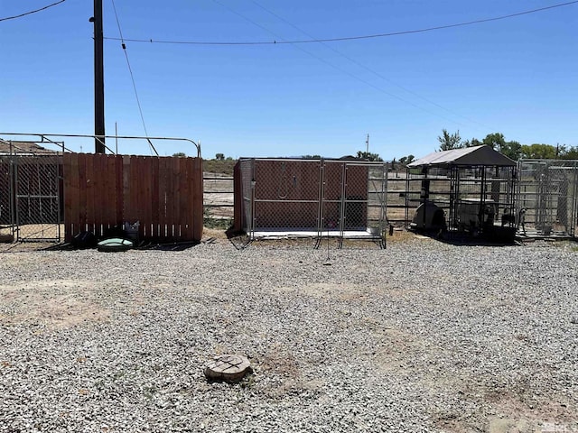 view of yard with an outdoor structure and fence