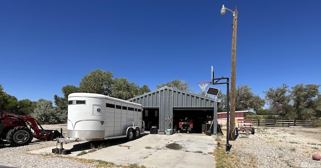 view of outdoor structure with an outbuilding and fence