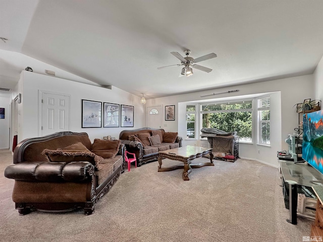 living room featuring lofted ceiling, ceiling fan, and light carpet