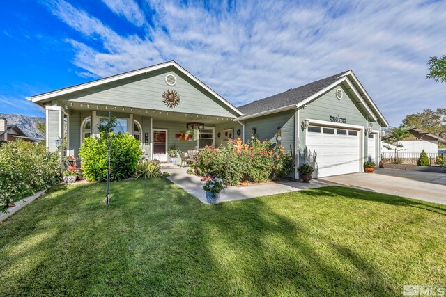 view of front of home with a garage, a front yard, and a porch