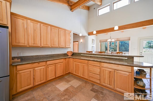 kitchen featuring stainless steel fridge, kitchen peninsula, and tile patterned floors