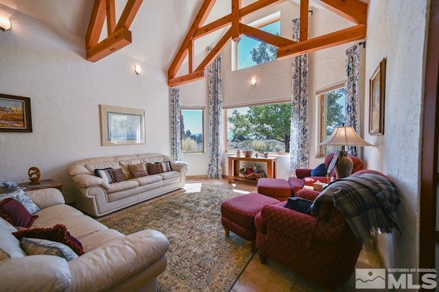 living room with high vaulted ceiling and beamed ceiling