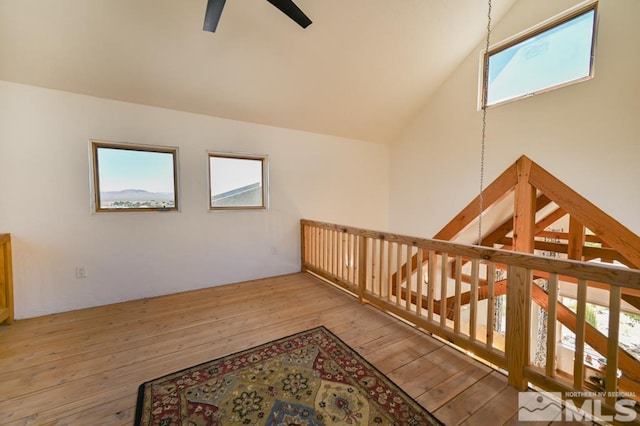 interior space with ceiling fan, light hardwood / wood-style flooring, lofted ceiling, and a healthy amount of sunlight