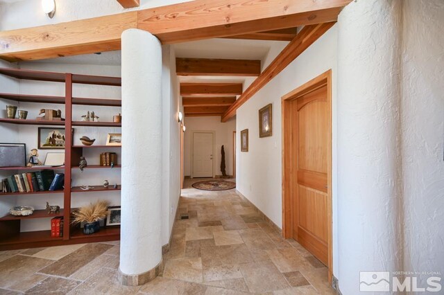 corridor with beam ceiling and light tile patterned floors