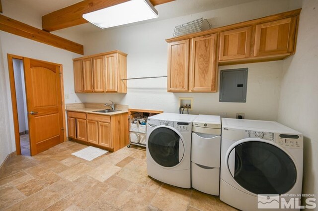 clothes washing area featuring electric panel, separate washer and dryer, sink, cabinets, and light tile patterned floors