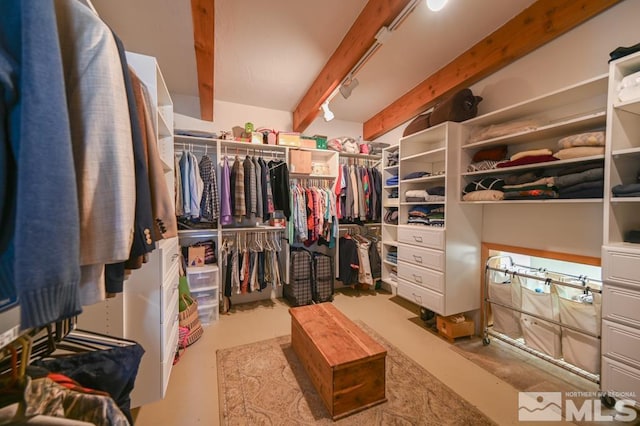 spacious closet featuring beam ceiling