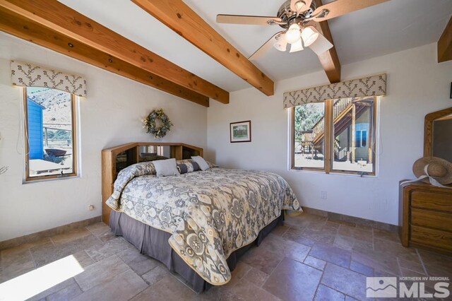 tiled bedroom featuring ceiling fan and beamed ceiling