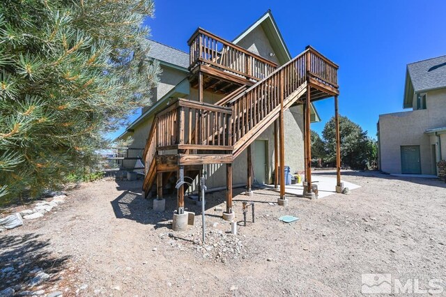 rear view of house featuring a deck