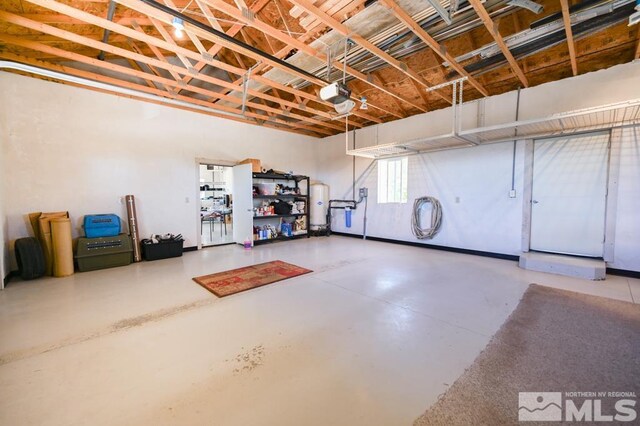 garage with gas water heater and a garage door opener