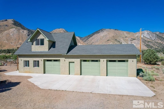 exterior space with a mountain view and a garage