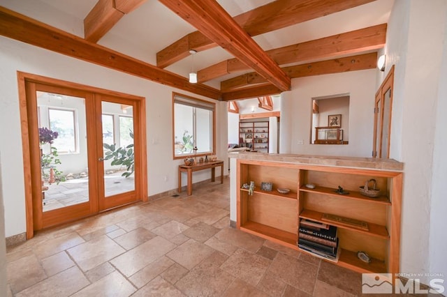 doorway to outside with beam ceiling, light tile patterned floors, and french doors