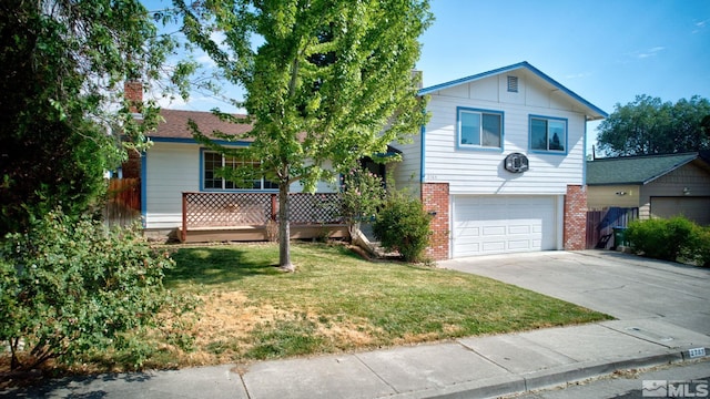 view of front of home with a front yard and a garage