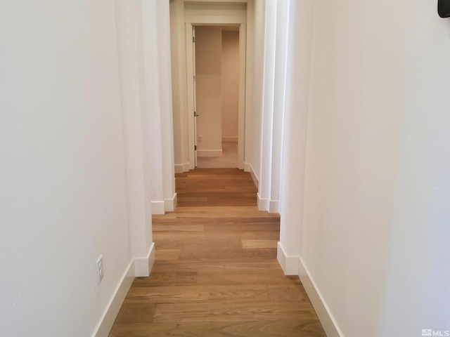 corridor with light wood-type flooring