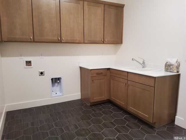 laundry area with cabinets, dark tile patterned flooring, sink, washer hookup, and hookup for an electric dryer