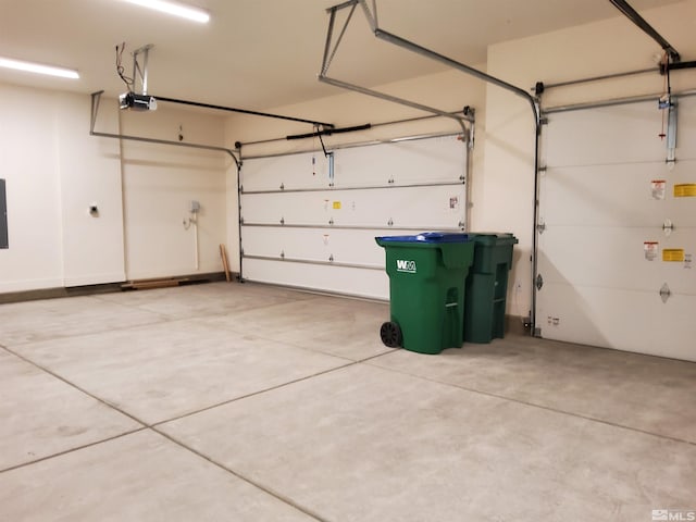 garage featuring electric panel and a garage door opener