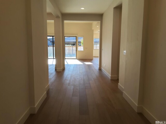 corridor with hardwood / wood-style floors