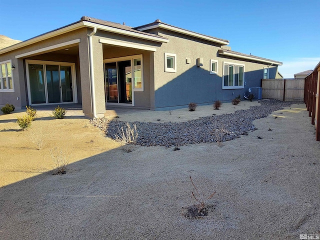 rear view of property featuring a patio and central AC