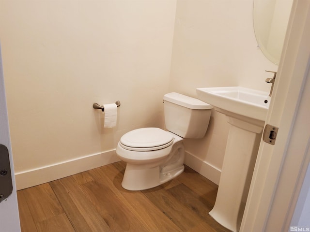 bathroom with wood-type flooring and toilet