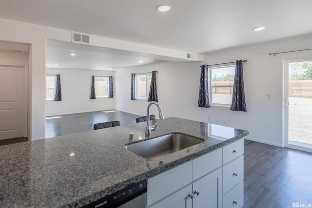 kitchen with sink, dark hardwood / wood-style floors, white cabinetry, and dark stone countertops