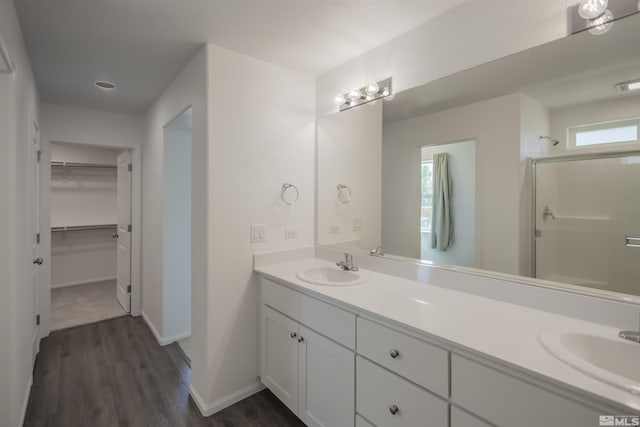 bathroom featuring hardwood / wood-style floors, vanity, an enclosed shower, and a healthy amount of sunlight