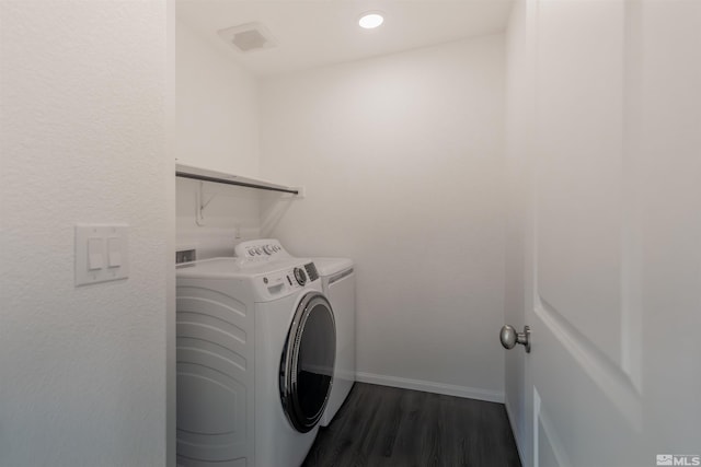 washroom featuring washer and dryer and dark hardwood / wood-style flooring