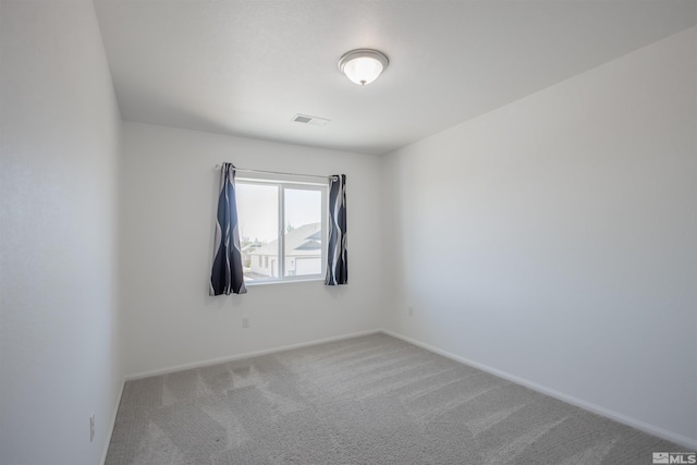 unfurnished room featuring carpet