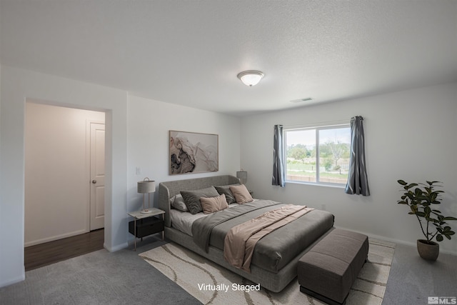 carpeted bedroom featuring a textured ceiling