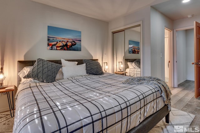 bedroom featuring light hardwood / wood-style floors and a closet