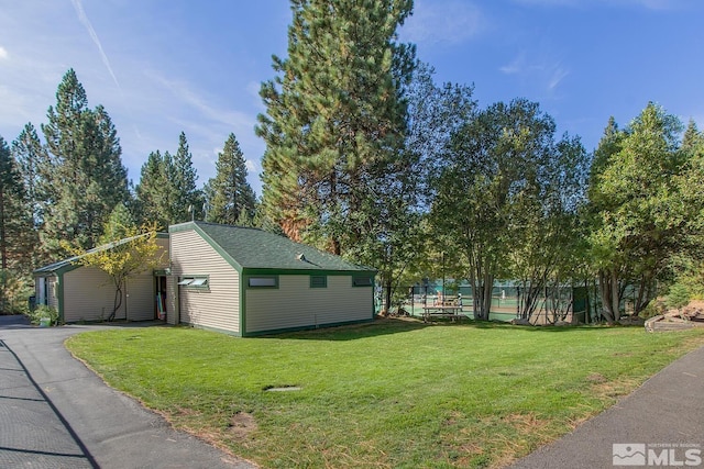 view of property exterior with a lawn