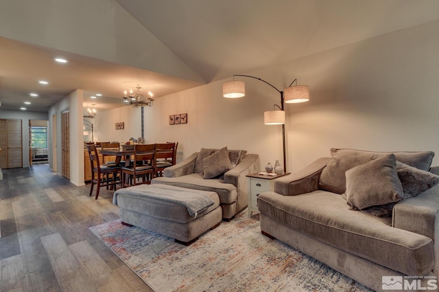 living room with high vaulted ceiling, a chandelier, and wood-type flooring