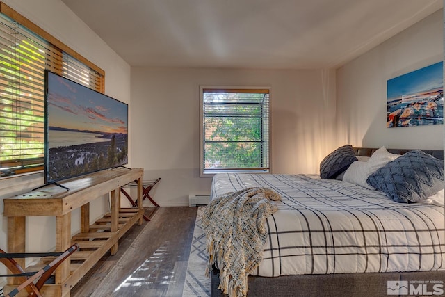 bedroom featuring baseboard heating and wood-type flooring