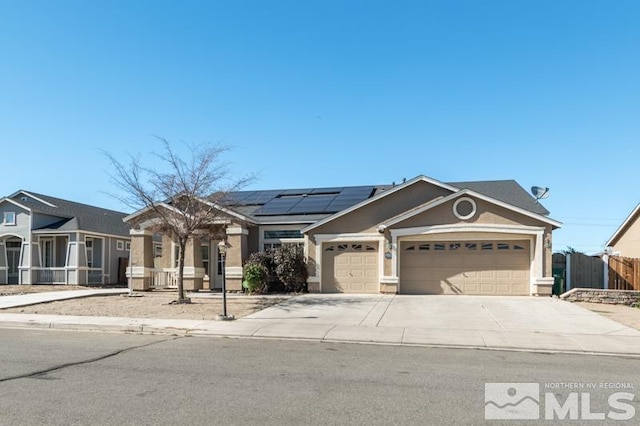 view of front of house featuring solar panels and a garage