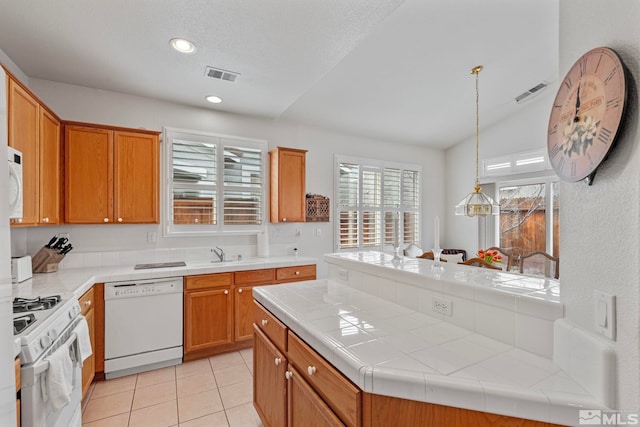 kitchen with white appliances, visible vents, tile countertops, and light tile patterned floors