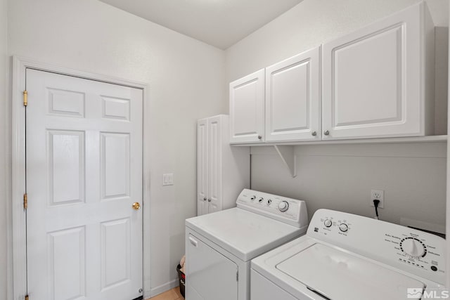 laundry area featuring cabinet space and separate washer and dryer