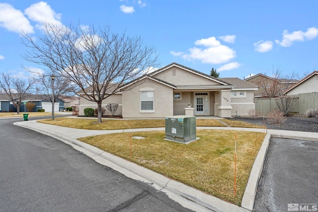 ranch-style house featuring central air condition unit, fence, stucco siding, uncovered parking, and a front lawn