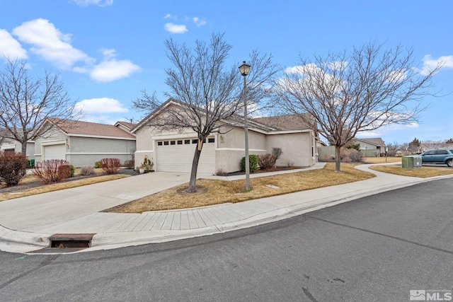 view of front of home featuring a garage, concrete driveway, and stucco siding