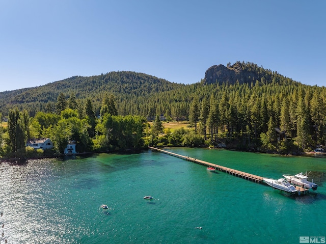 view of water feature featuring a dock and a mountain view